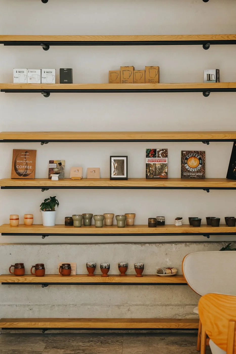 Open wooden shelves with books and ceramics