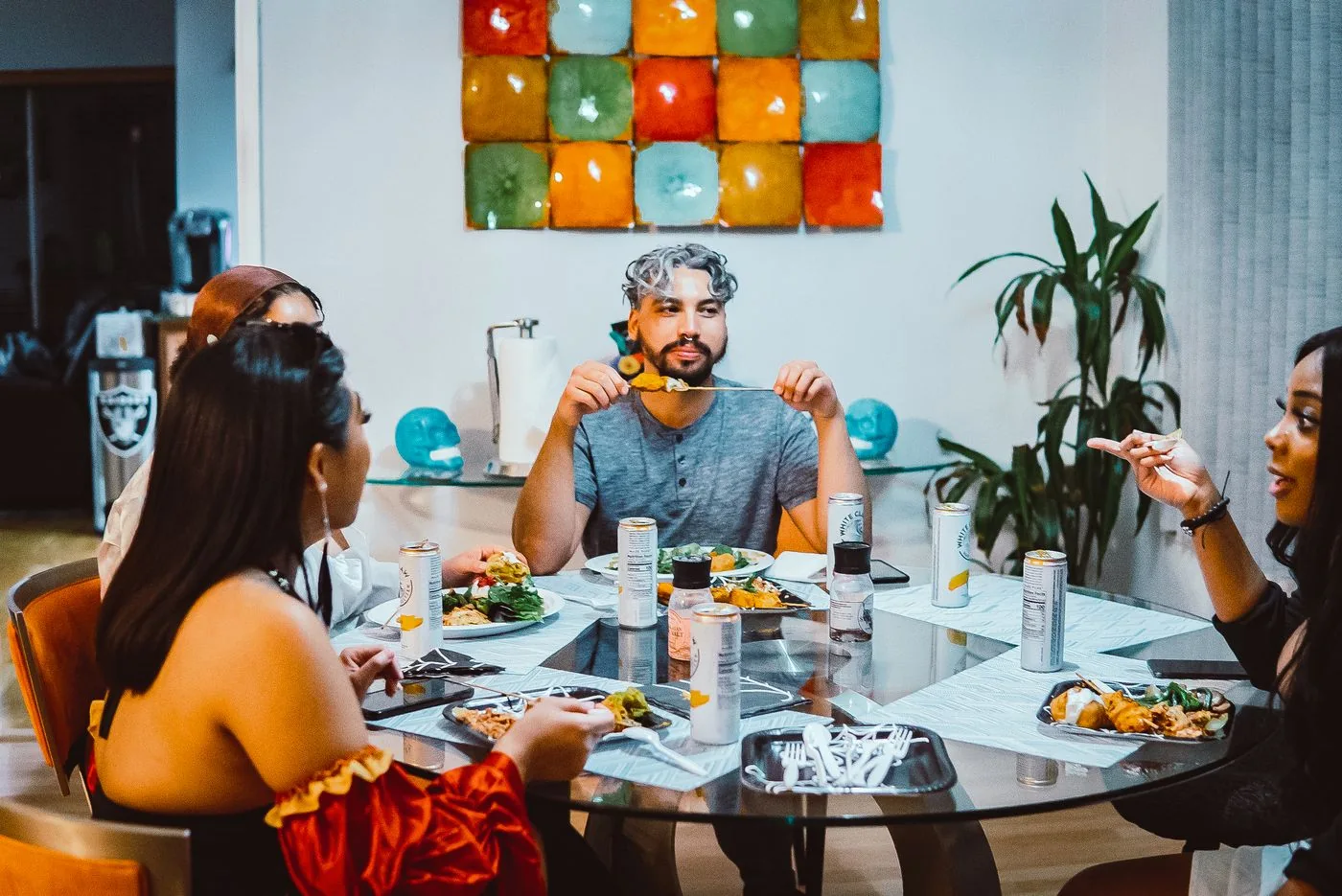 Friends sharing food around a home dinner table