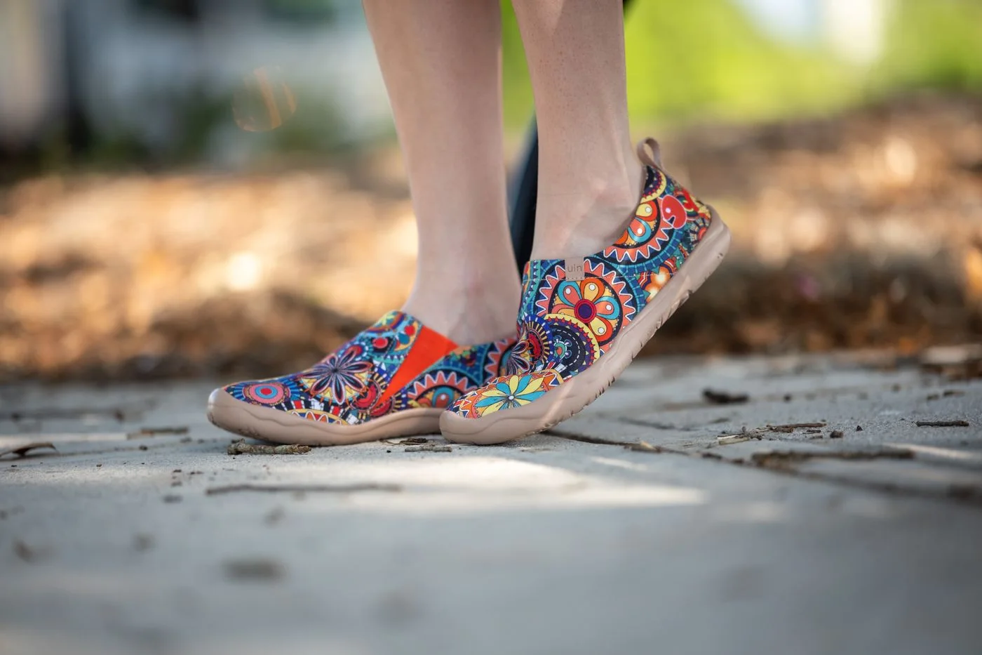 Colourfully patterned lace-up shoes worn outdoors.