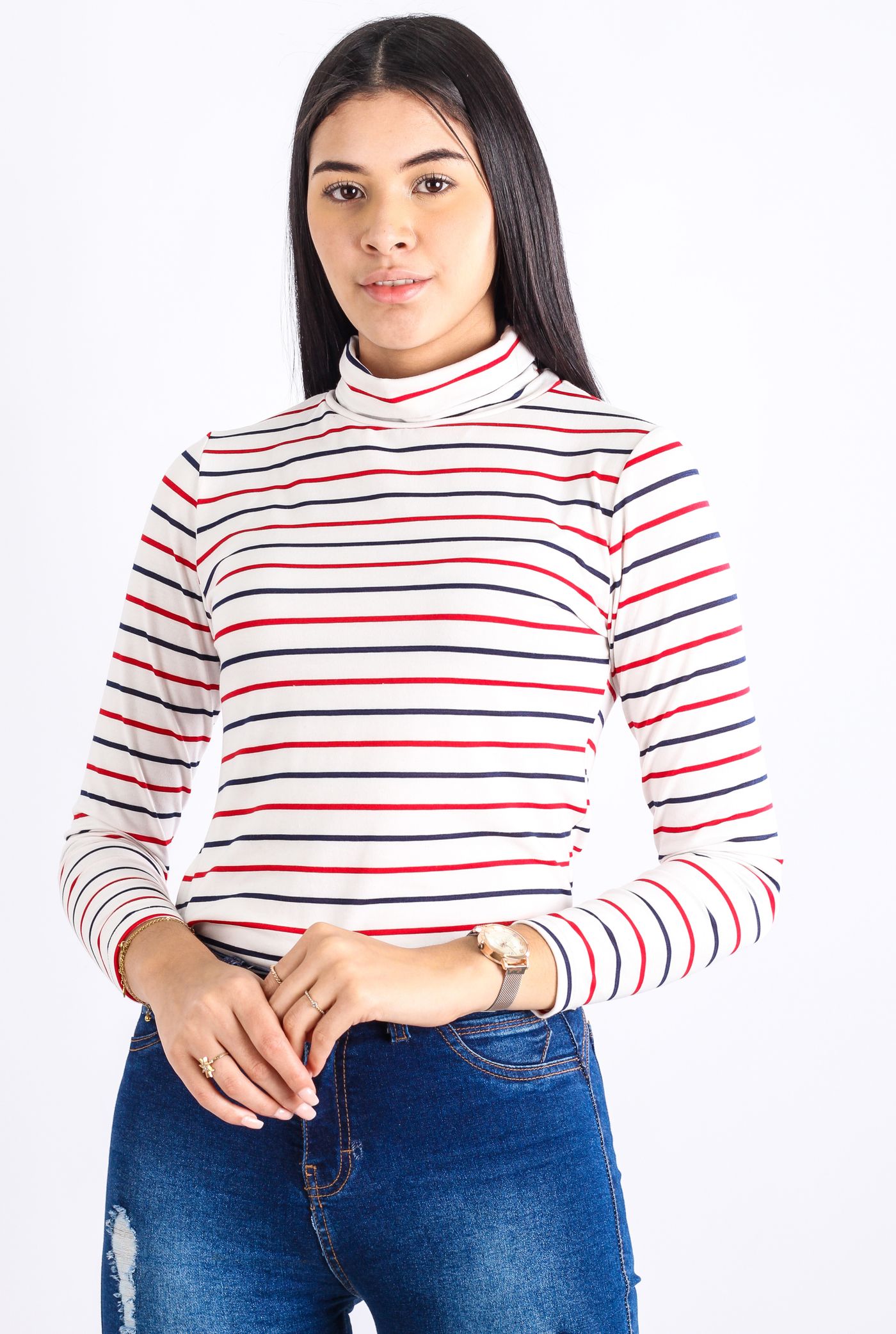 Woman wearing a striped long-sleeve top and jeans against a white background