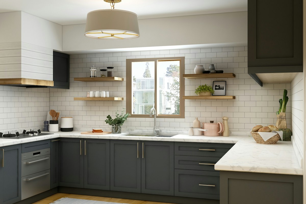 A kitchen with dark lower cabinets and pale countertops.